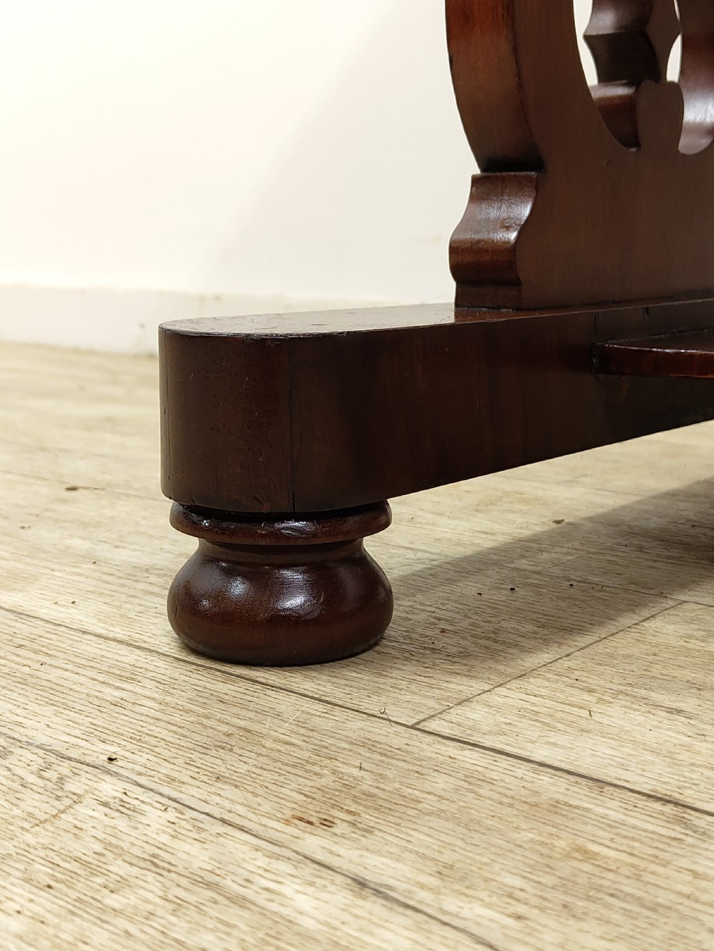 A Victorian mahogany washstand with a rectangular white marble top resting on twin pierced trestle supports linked by a shaped stretcher. View XV