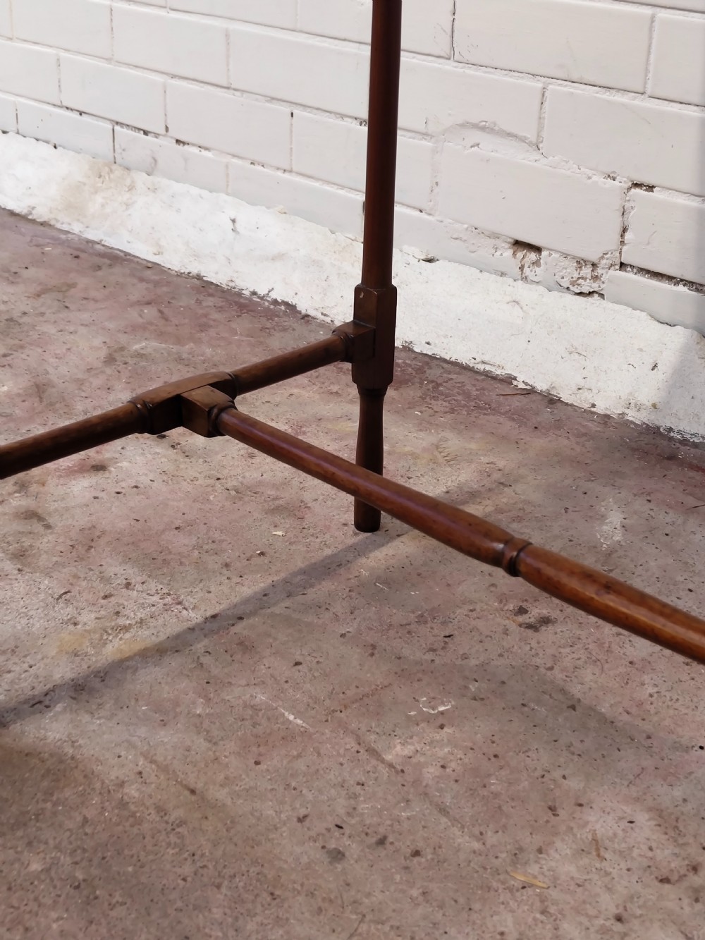 A tall Edwardian mahogany occasional table featuring a tray top with raised edges and slender spider legs connected by lower stretchers. View XV