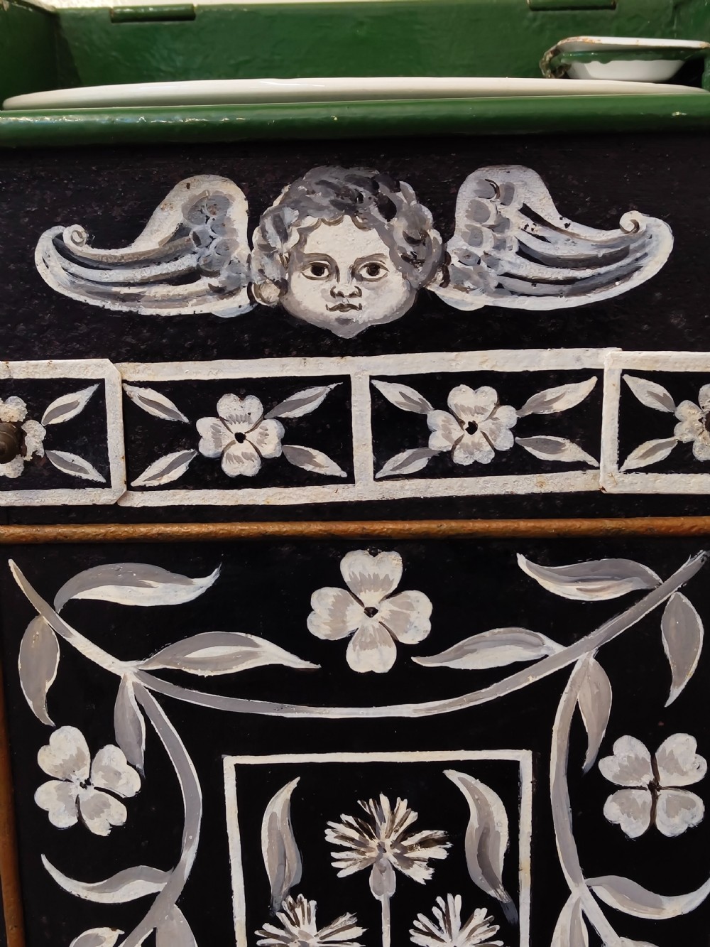 A hand-painted black and green metal toleware washstand with an open lid revealing a circular mirror and a fitted ceramic washbasin. View VII