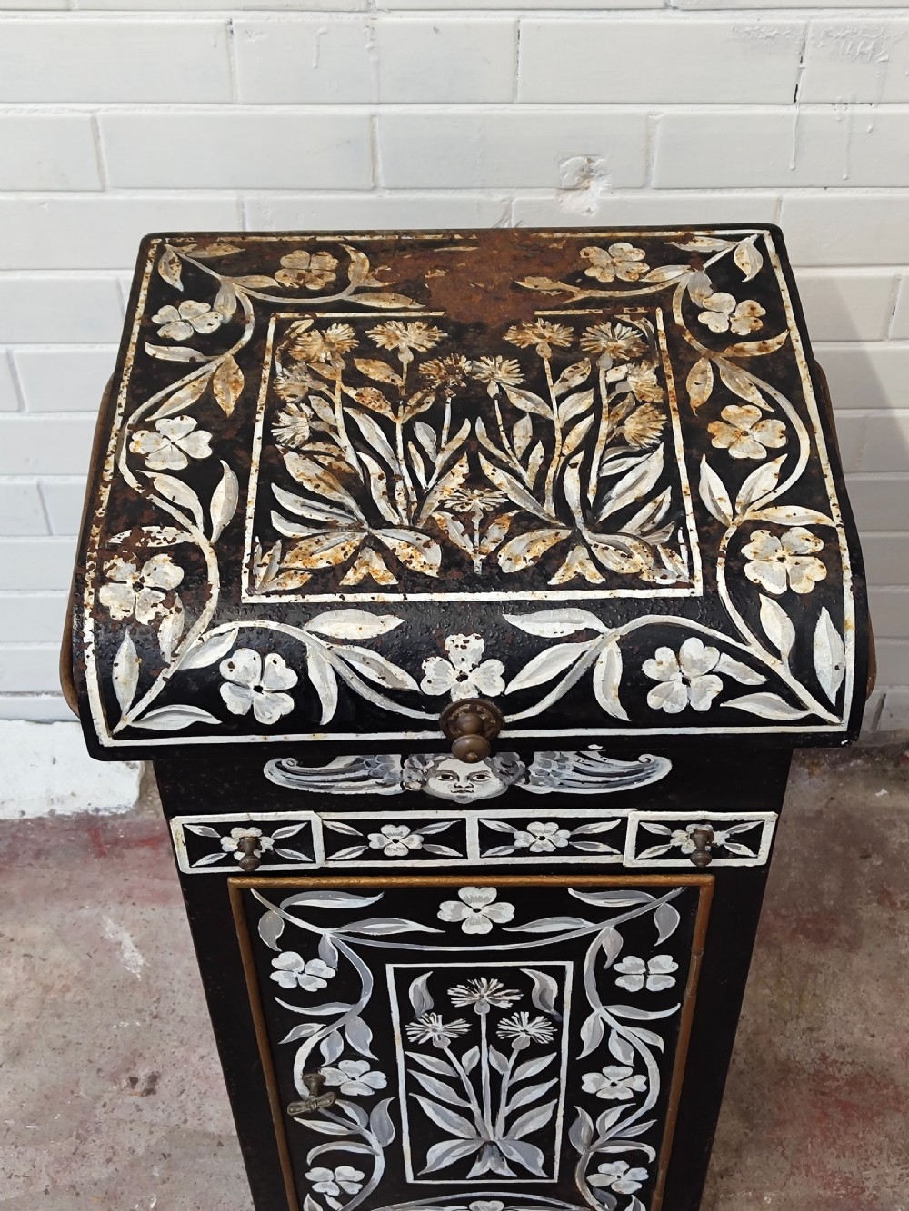 A hand-painted black and green metal toleware washstand with an open lid revealing a circular mirror and a fitted ceramic washbasin. View VIII