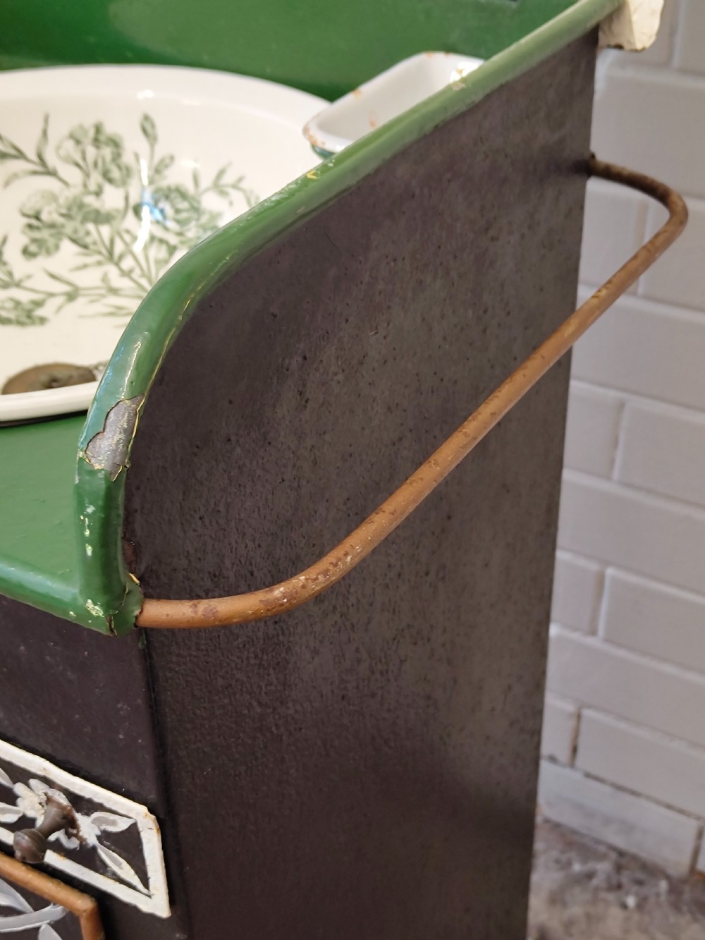 A hand-painted black and green metal toleware washstand with an open lid revealing a circular mirror and a fitted ceramic washbasin. View XI