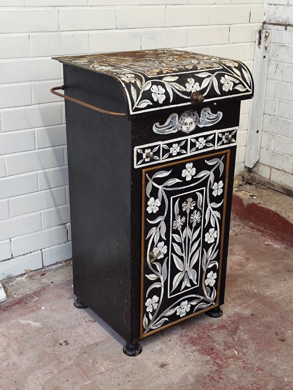 A hand-painted black and green metal toleware washstand with an open lid revealing a circular mirror and a fitted ceramic washbasin. View XV
