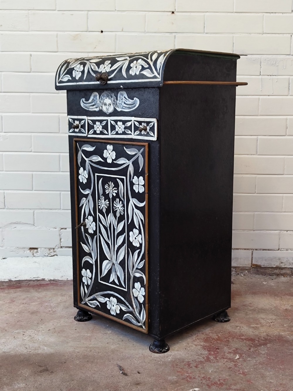 A hand-painted black and green metal toleware washstand with an open lid revealing a circular mirror and a fitted ceramic washbasin. View XVIII