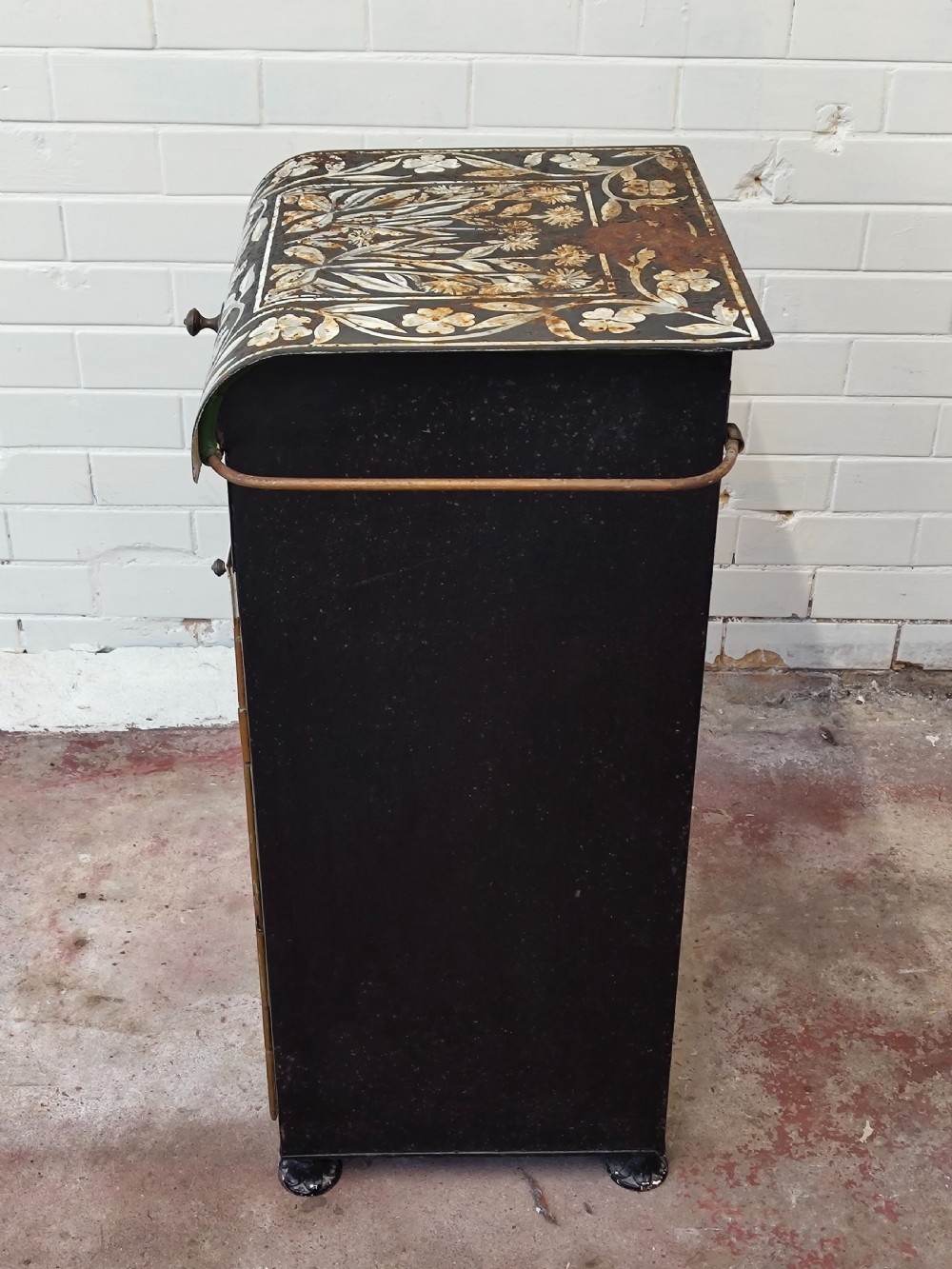A hand-painted black and green metal toleware washstand with an open lid revealing a circular mirror and a fitted ceramic washbasin. View XXIII