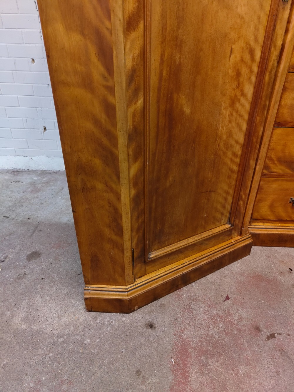 Victorian satin birch corner compactum wardrobe featuring arched panelled doors, brass hardware, and a integrated chest of drawers. View II