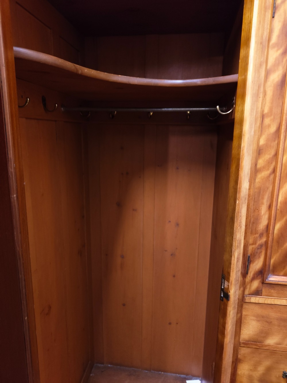 Victorian satin birch corner compactum wardrobe featuring arched panelled doors, brass hardware, and a integrated chest of drawers. View XI