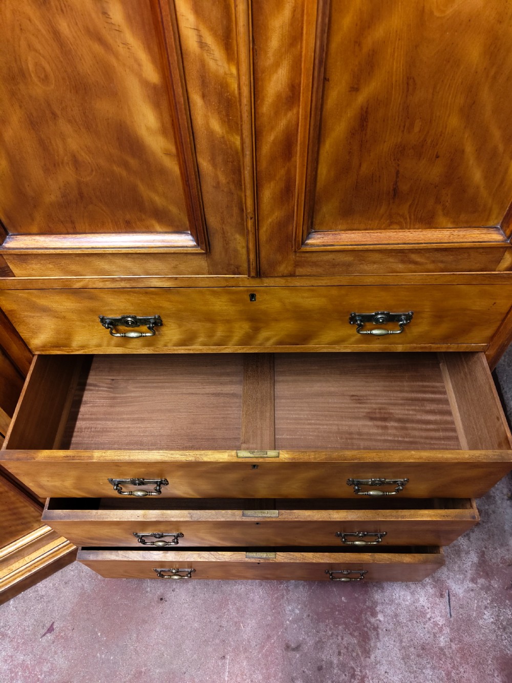 Victorian satin birch corner compactum wardrobe featuring arched panelled doors, brass hardware, and a integrated chest of drawers. View XIX