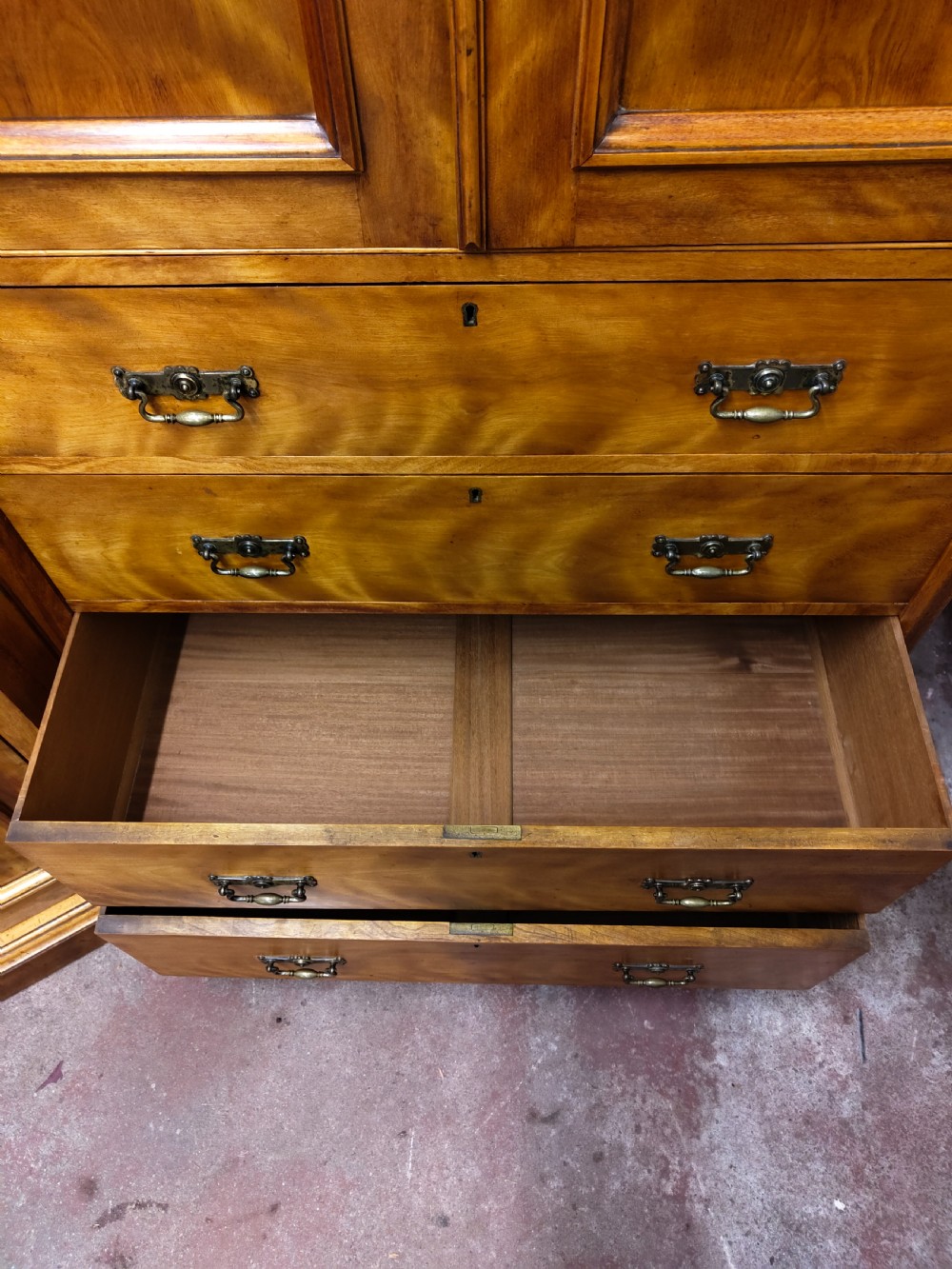 Victorian satin birch corner compactum wardrobe featuring arched panelled doors, brass hardware, and a integrated chest of drawers. View XX