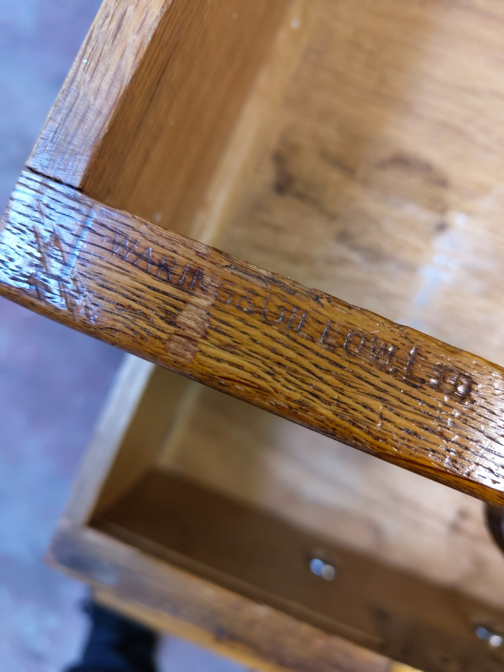 A large golden oak Art Deco partners desk featuring reeded corner details, dual pedestals with drawers, and metal pull handles. View IV