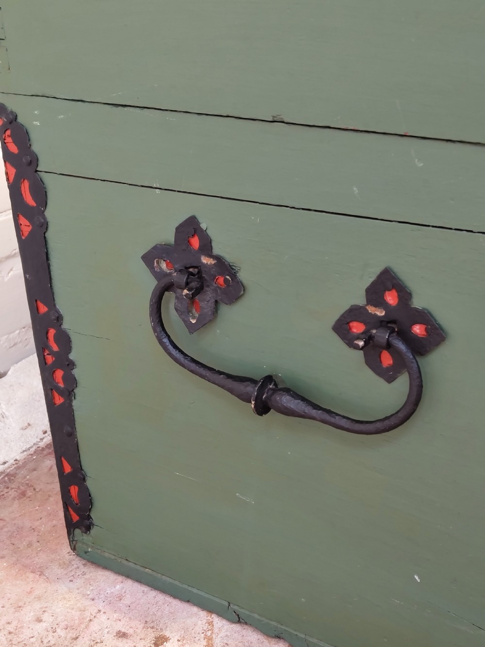 A green painted wooden dome top trunk featuring black decorative iron straps, red painted initials AH, and the date 1709. View IX