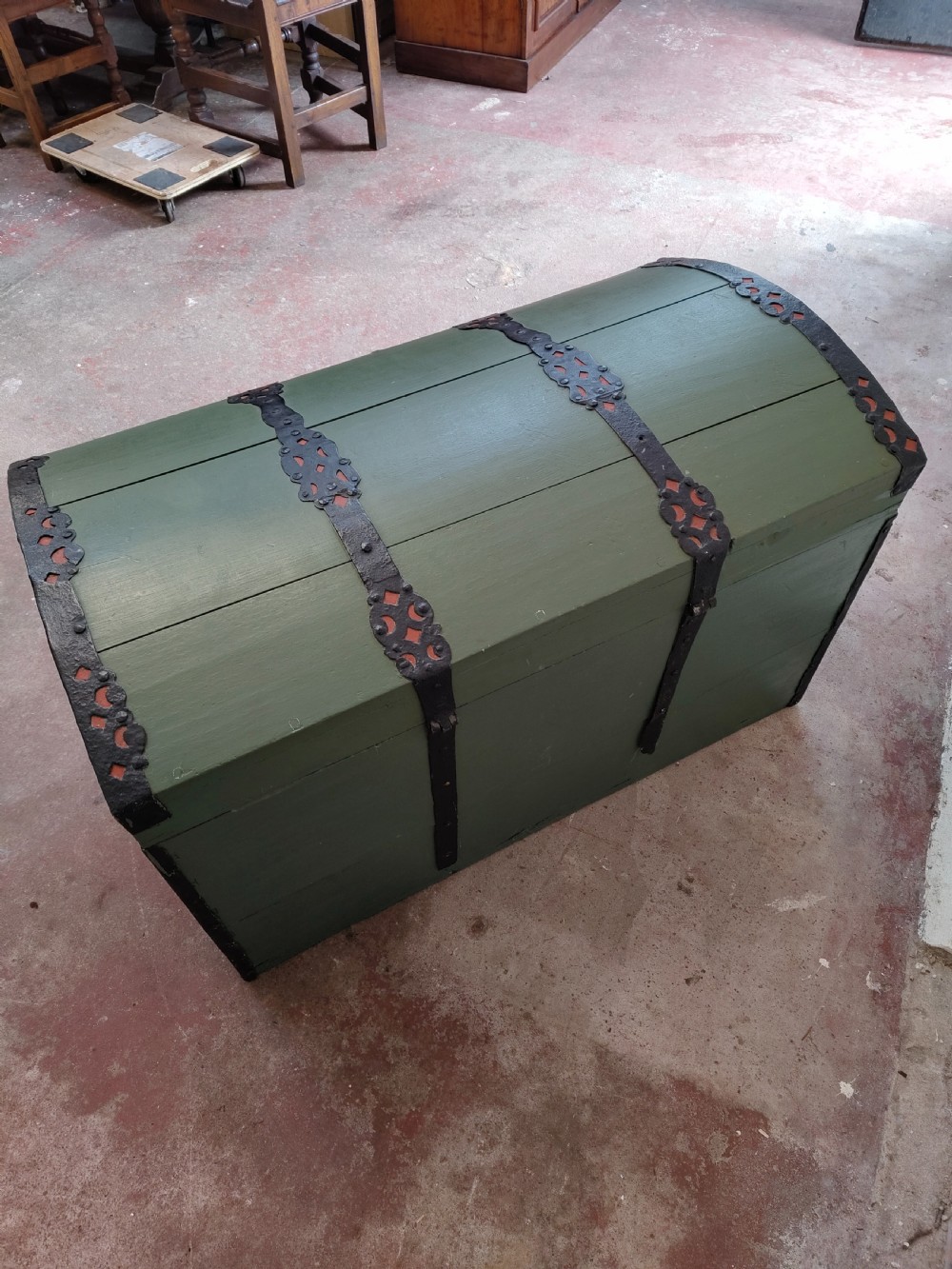 A green painted wooden dome top trunk featuring black decorative iron straps, red painted initials AH, and the date 1709. View XIII