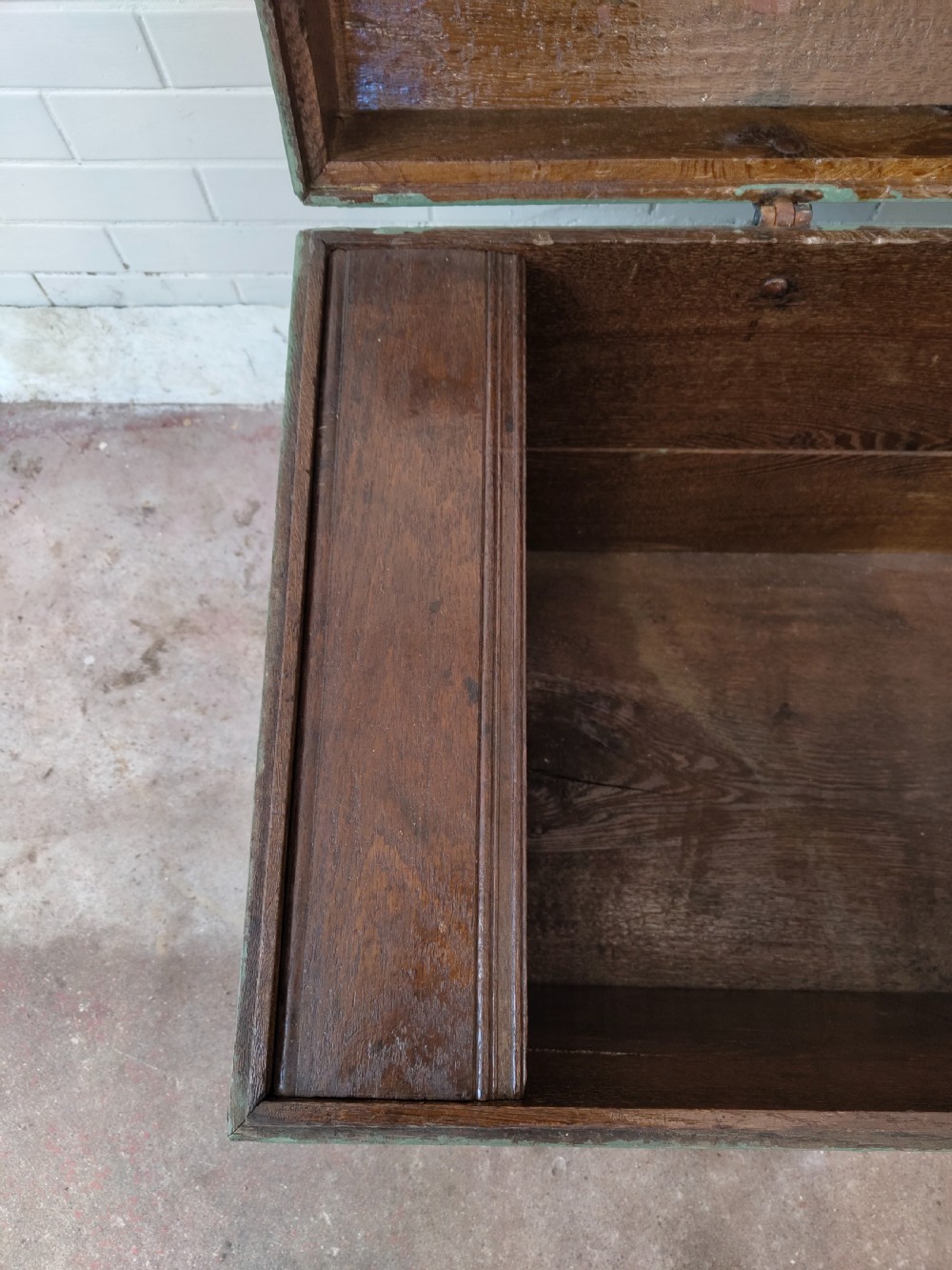 A green painted wooden dome top trunk featuring black decorative iron straps, red painted initials AH, and the date 1709. View XIV