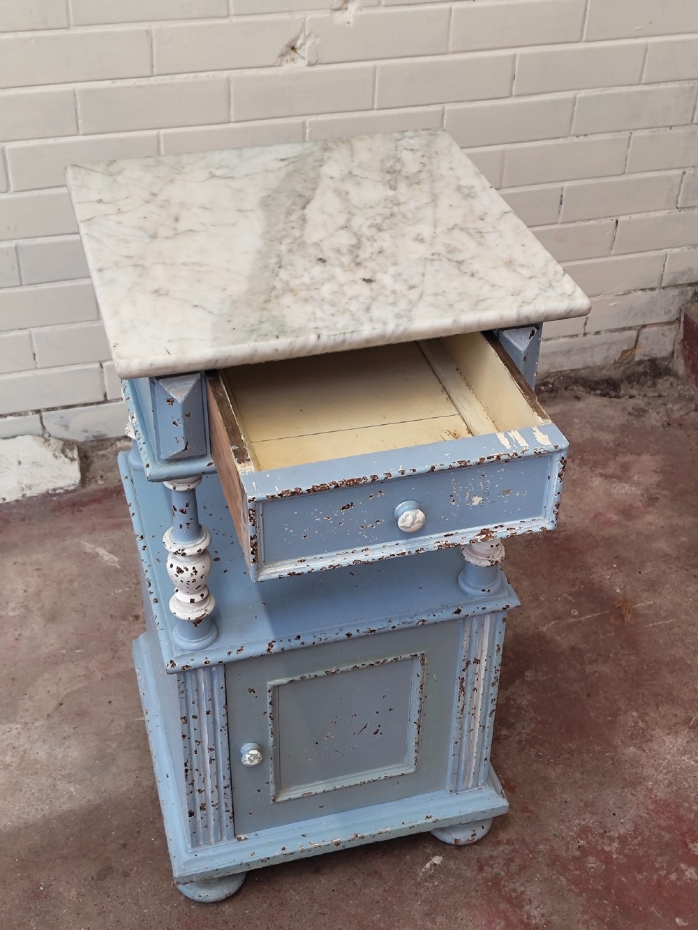 A pair of light blue painted French bedside tables featuring marble tops, single drawers, turned spindle columns, and bottom cupboards. View II