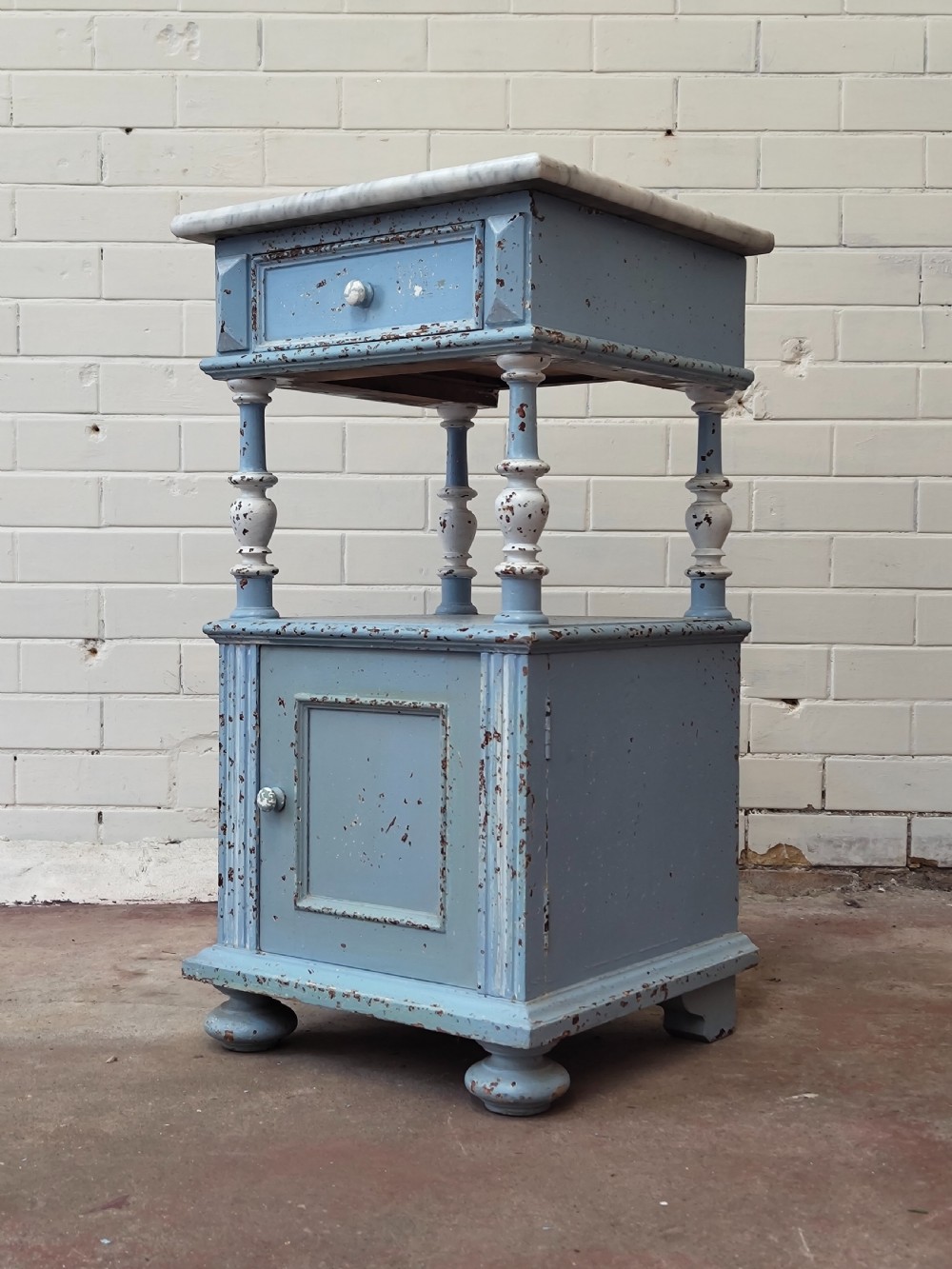 A pair of light blue painted French bedside tables featuring marble tops, single drawers, turned spindle columns, and bottom cupboards. View IV