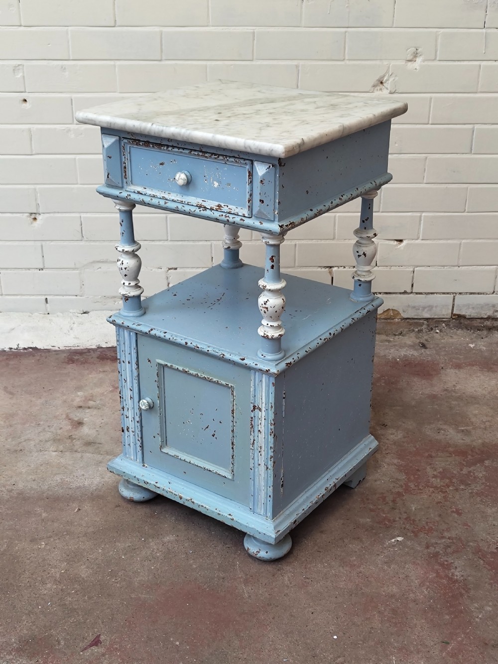 A pair of light blue painted French bedside tables featuring marble tops, single drawers, turned spindle columns, and bottom cupboards. View V