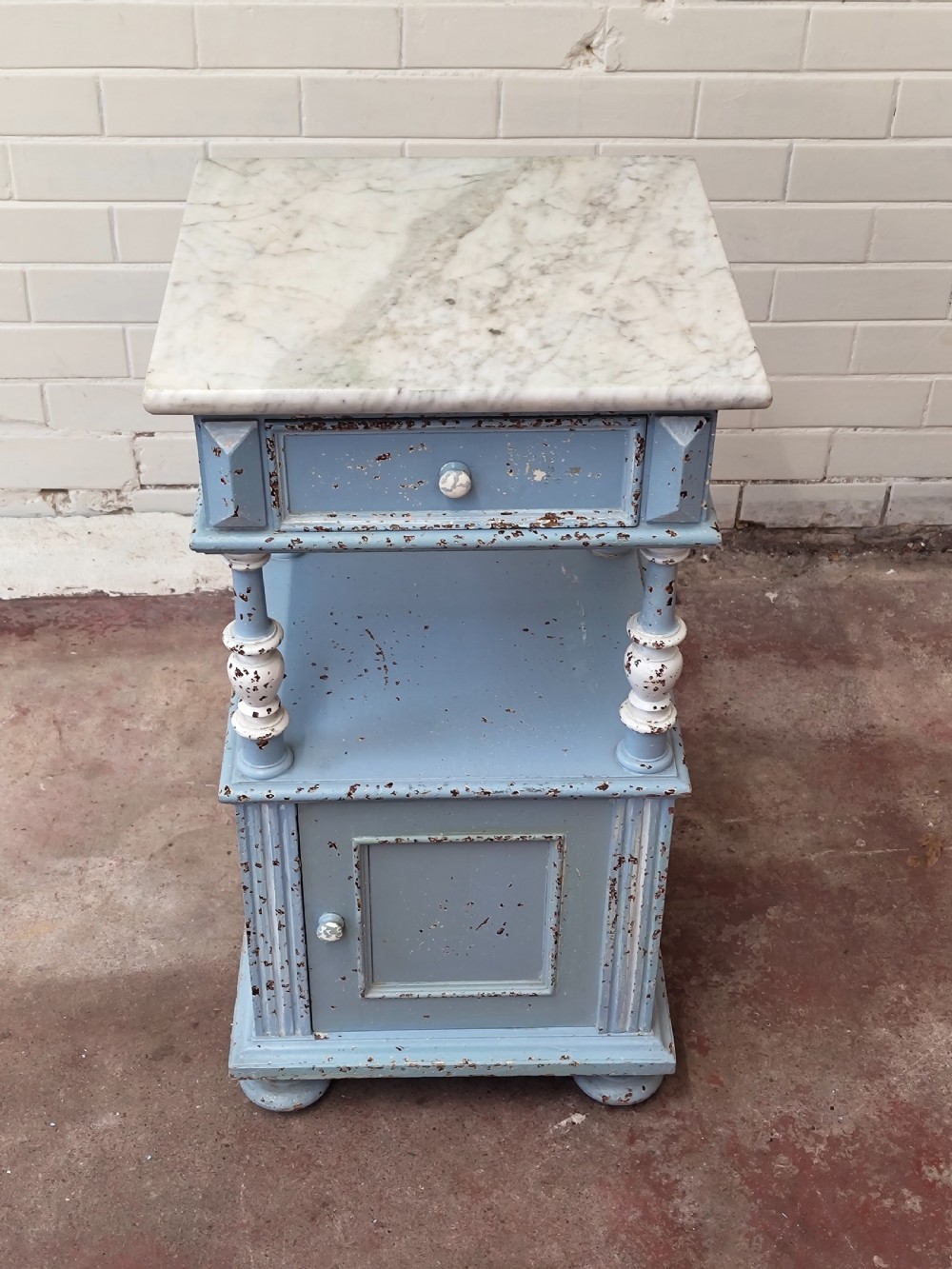 A pair of light blue painted French bedside tables featuring marble tops, single drawers, turned spindle columns, and bottom cupboards. View VI