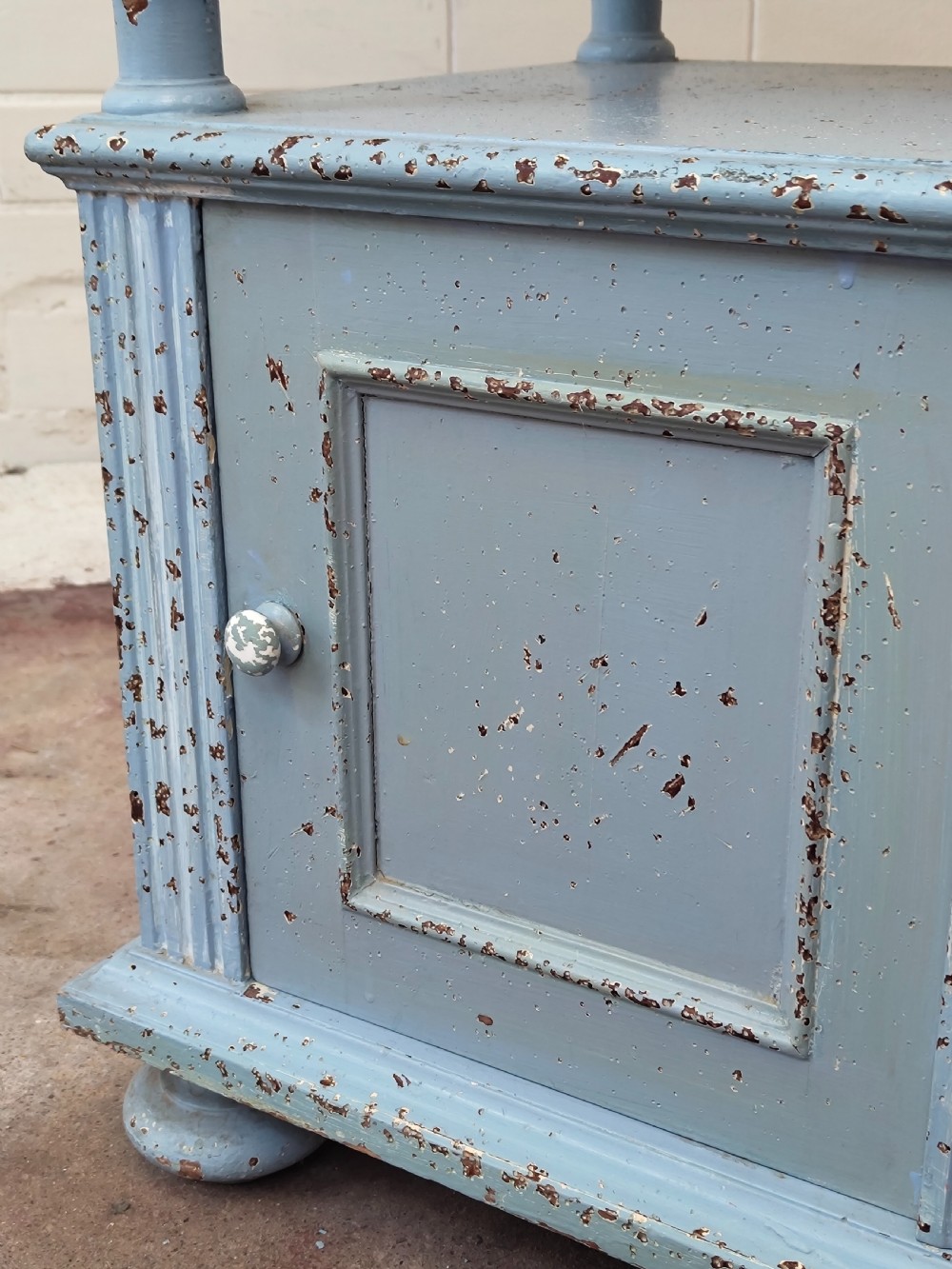 A pair of light blue painted French bedside tables featuring marble tops, single drawers, turned spindle columns, and bottom cupboards. View X