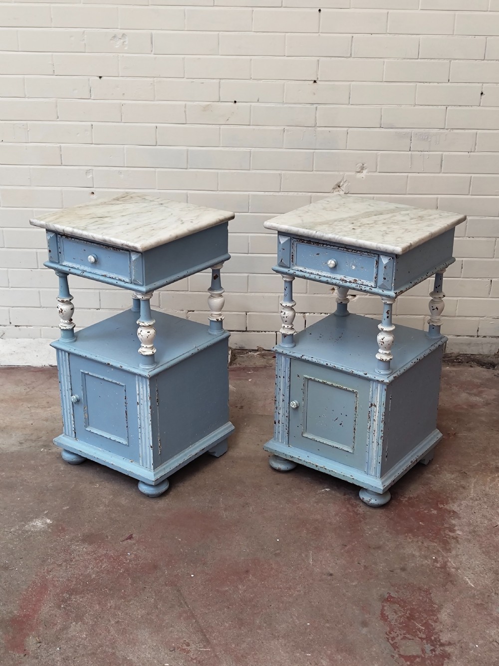 A pair of light blue painted French bedside tables featuring marble tops, single drawers, turned spindle columns, and bottom cupboards. View XII