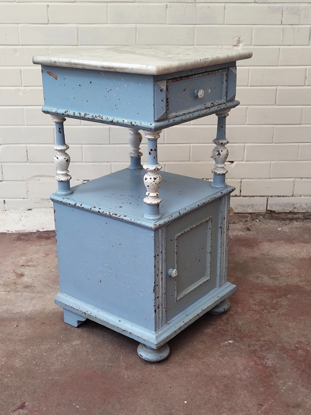 A pair of light blue painted French bedside tables featuring marble tops, single drawers, turned spindle columns, and bottom cupboards. View XVI
