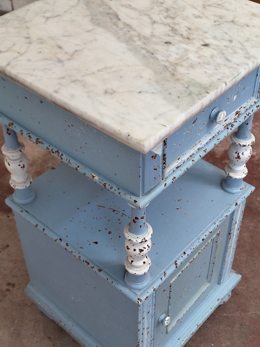 A pair of light blue painted French bedside tables featuring marble tops, single drawers, turned spindle columns, and bottom cupboards. View XXI