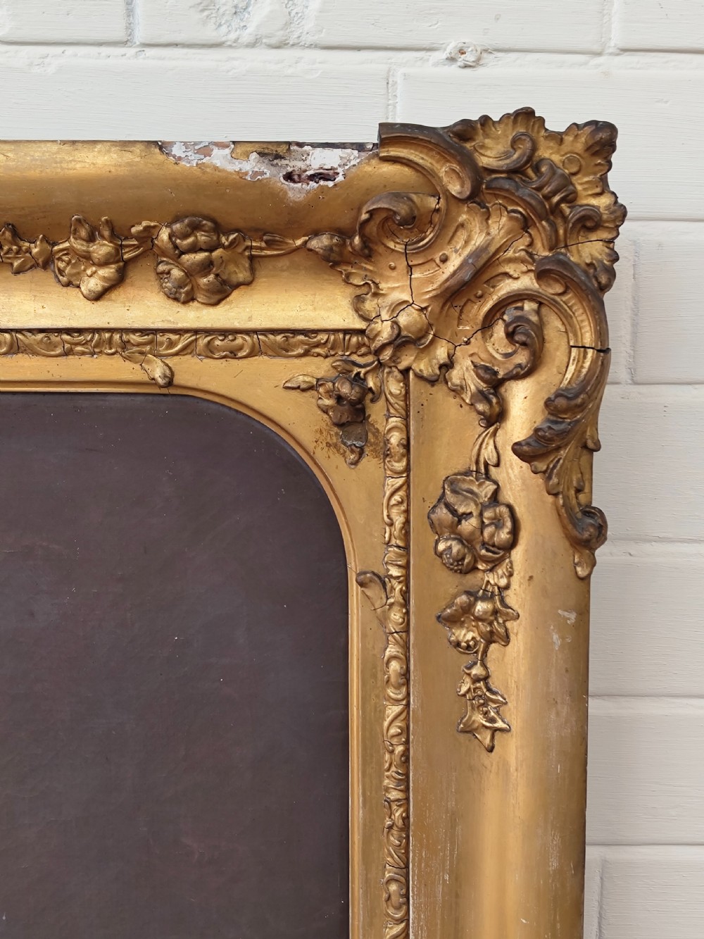 A Victorian oil painting depicting a seated gentleman in a dark suit set inside a large, ornate gilded gesso frame. View IV