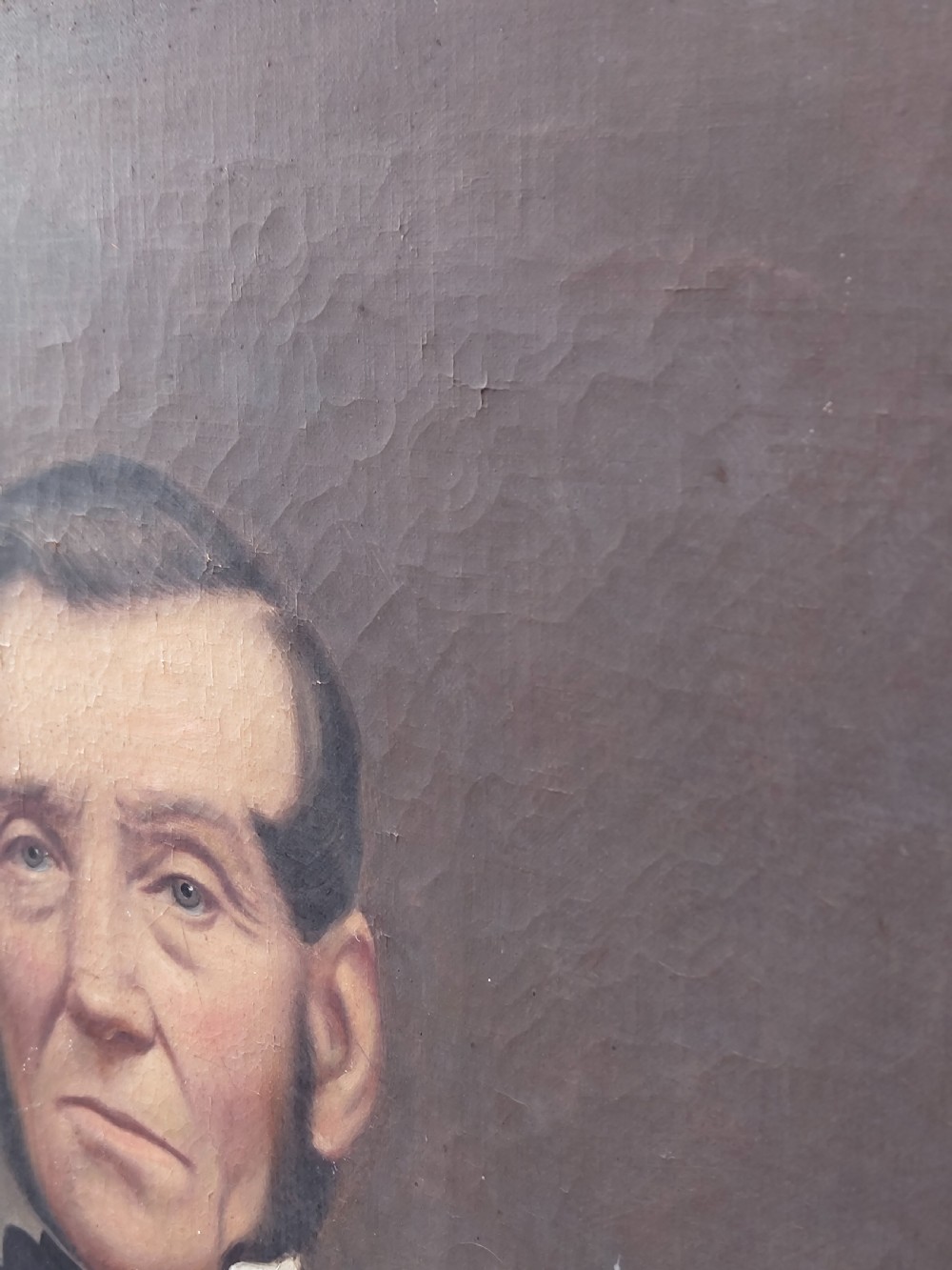 A Victorian oil painting depicting a seated gentleman in a dark suit set inside a large, ornate gilded gesso frame. View X