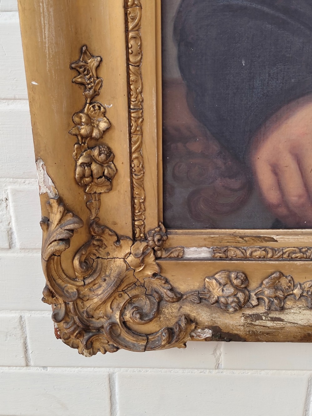 A Victorian oil painting depicting a seated gentleman in a dark suit set inside a large, ornate gilded gesso frame. View XII