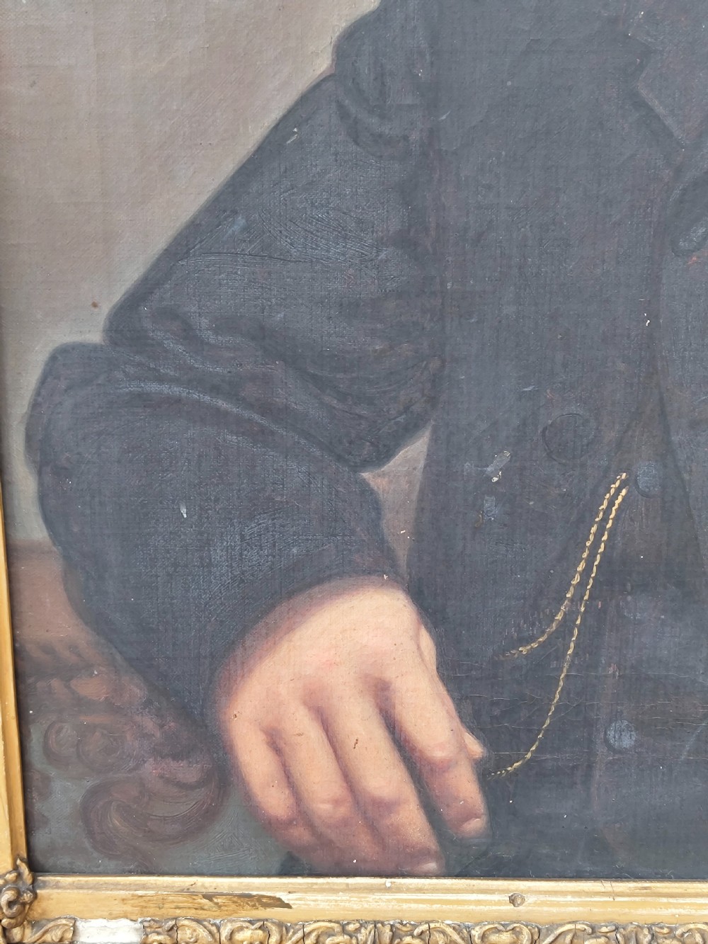 A Victorian oil painting depicting a seated gentleman in a dark suit set inside a large, ornate gilded gesso frame. View XVIII