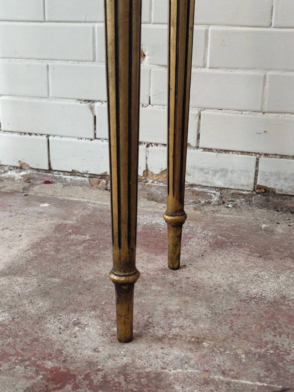 A diminutive French Louis XVI style giltwood console table with a red veined marble top, carved frieze, and slender tapered fluted legs. View III