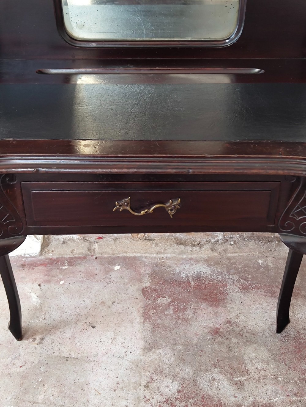 A dark mahogany Victorian ladies writing desk featuring slender cabriole legs, a single drawer, carved lattice details, and a raised back structure with a small central mirror. View III