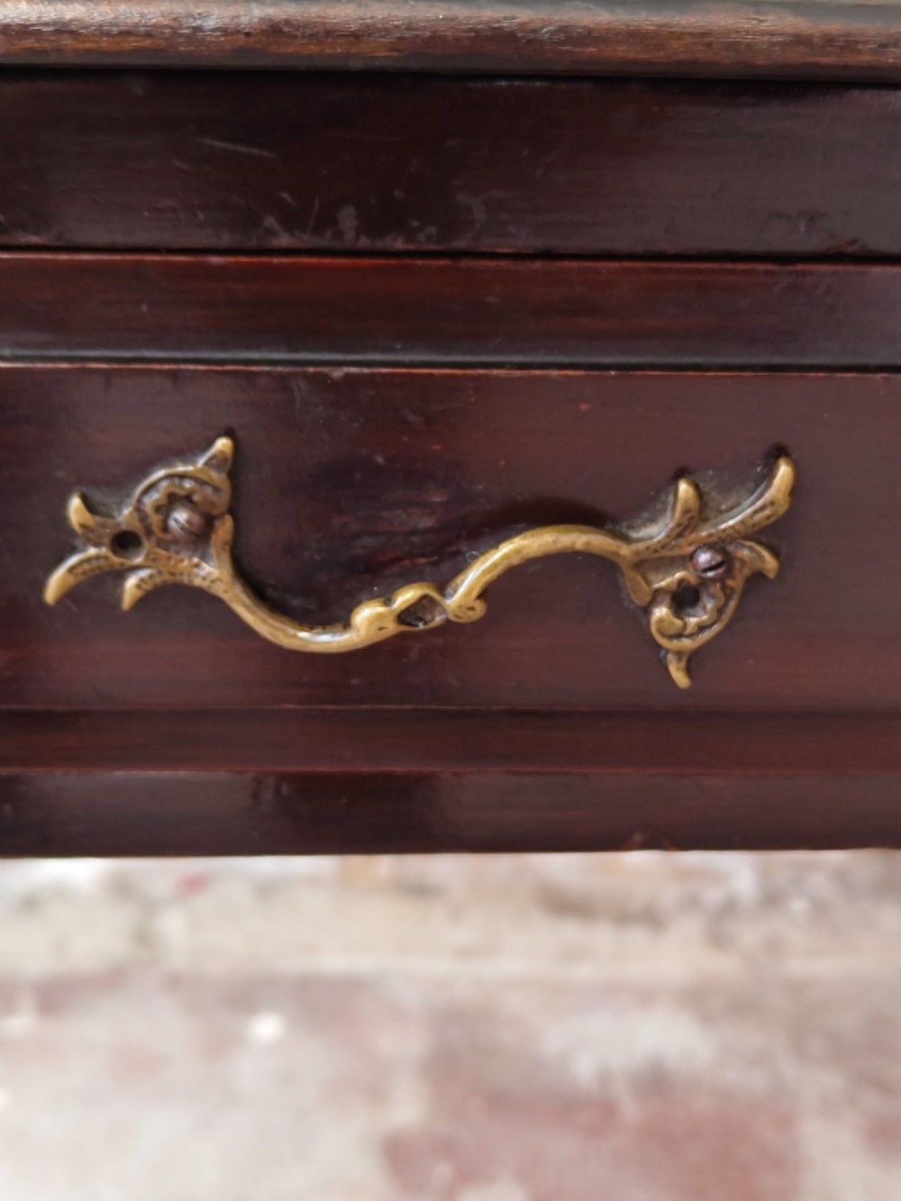 A dark mahogany Victorian ladies writing desk featuring slender cabriole legs, a single drawer, carved lattice details, and a raised back structure with a small central mirror. View IV