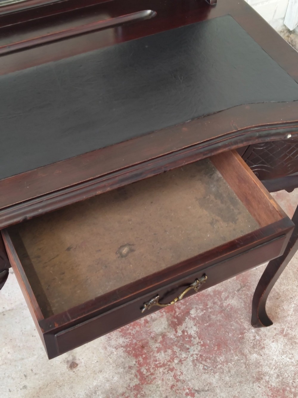 A dark mahogany Victorian ladies writing desk featuring slender cabriole legs, a single drawer, carved lattice details, and a raised back structure with a small central mirror. View V