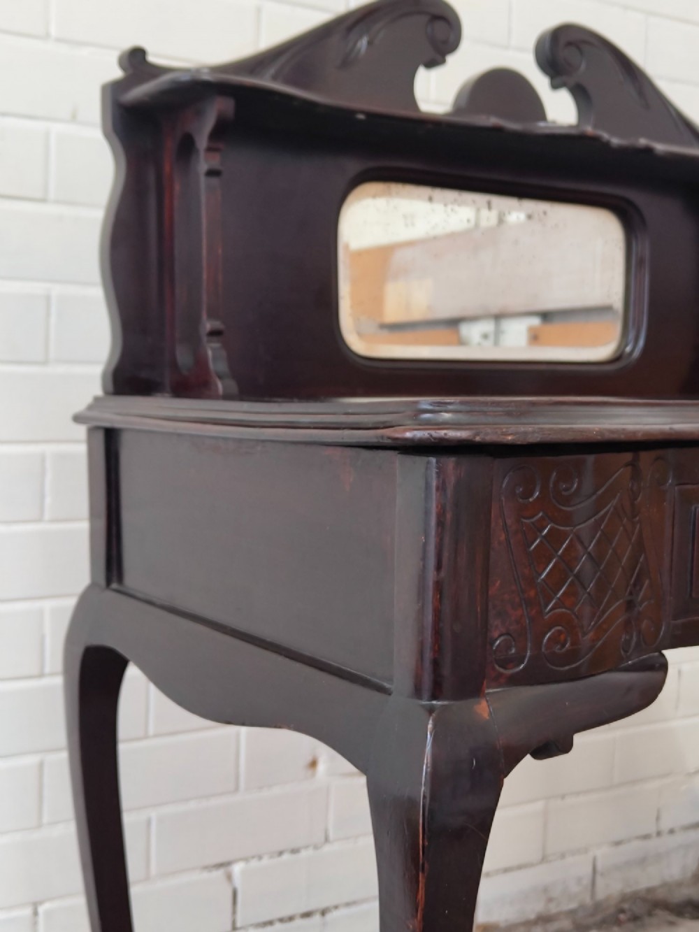 A dark mahogany Victorian ladies writing desk featuring slender cabriole legs, a single drawer, carved lattice details, and a raised back structure with a small central mirror. View XIII
