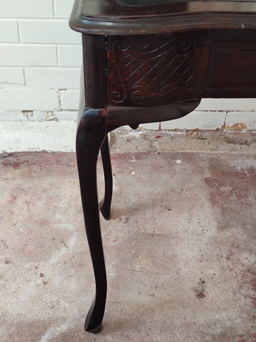 A dark mahogany Victorian ladies writing desk featuring slender cabriole legs, a single drawer, carved lattice details, and a raised back structure with a small central mirror. View XIV