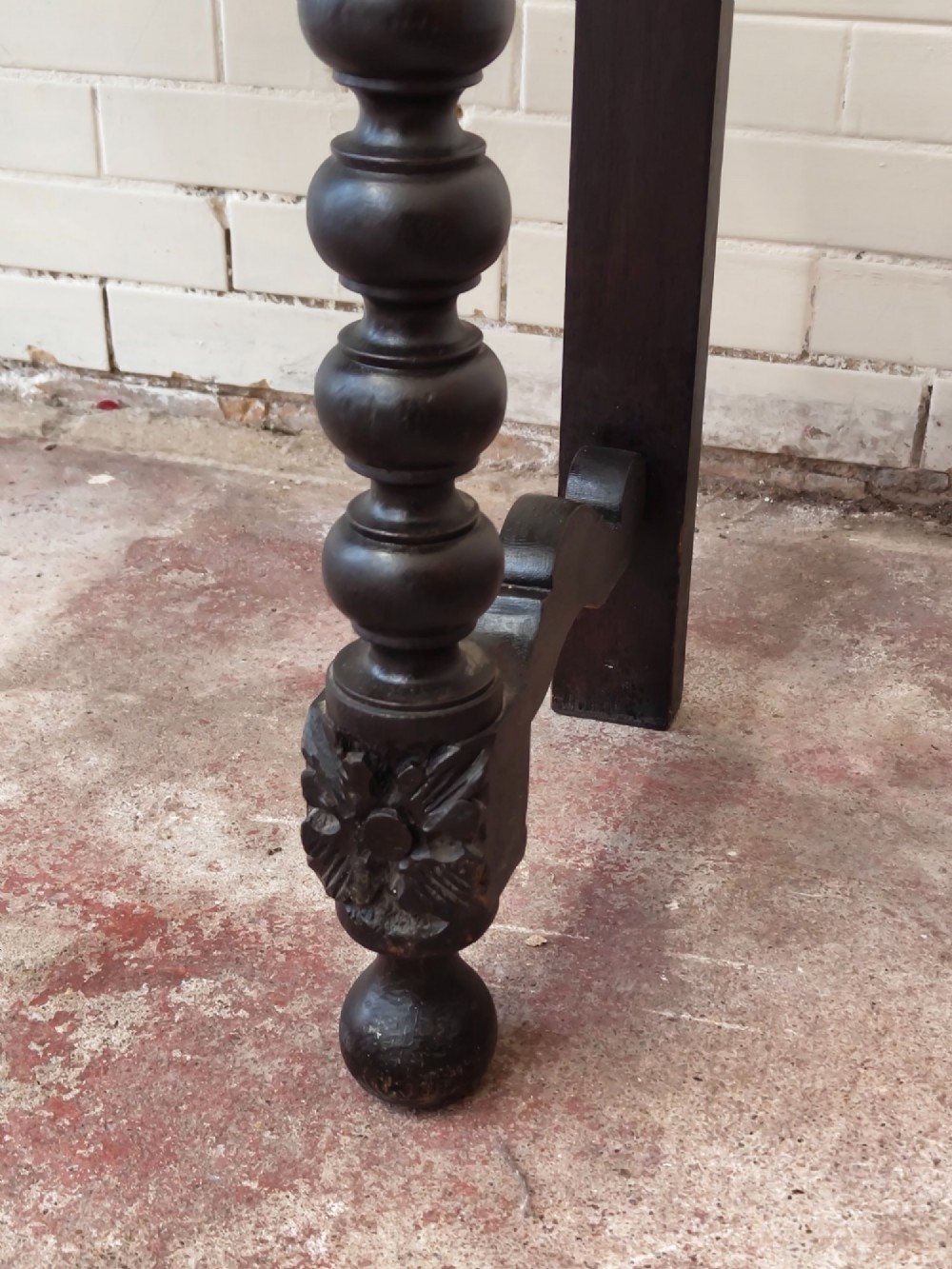 Dark carved oak hall table featuring a carved floral gallery, relief apron, bobbin-turned front legs, and lower stretcher. View III
