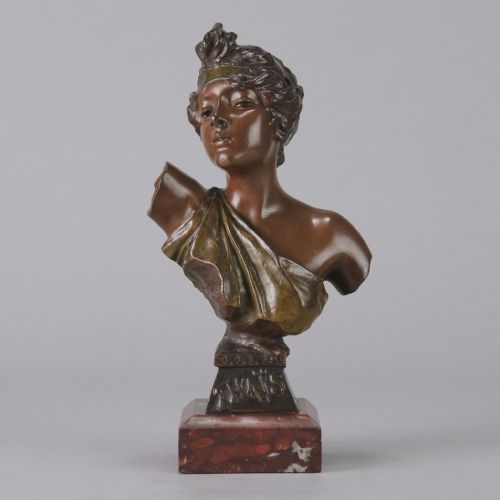 fig 2. An Art Nouveau bronze bust of a woman titled Thais mounted on a red marble base.