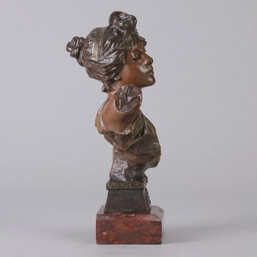 fig 3. An Art Nouveau bronze bust of a woman titled Thais mounted on a red marble base.