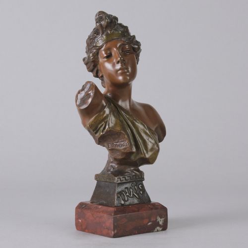 fig 4. An Art Nouveau bronze bust of a woman titled Thais mounted on a red marble base.