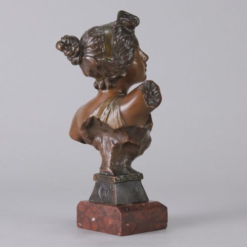 fig 5. An Art Nouveau bronze bust of a woman titled Thais mounted on a red marble base.