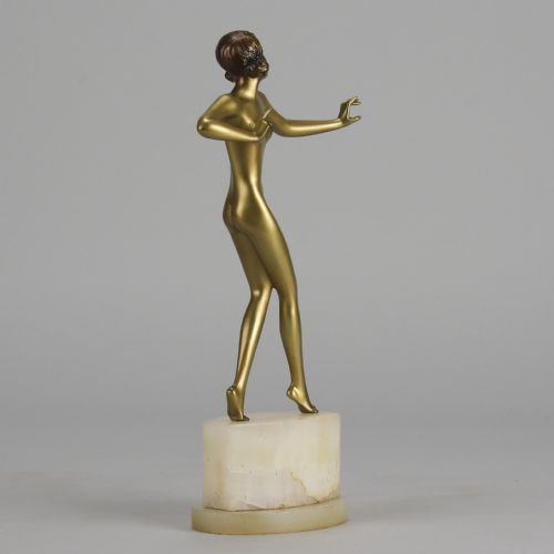 fig 2. An Art Deco cold-painted bronze figurine depicting a slender female dancer posed on a square onyx base.