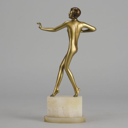 fig 3. An Art Deco cold-painted bronze figurine depicting a slender female dancer posed on a square onyx base.