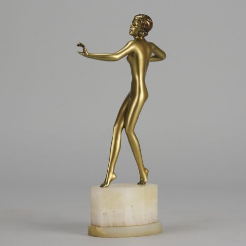 fig 4. An Art Deco cold-painted bronze figurine depicting a slender female dancer posed on a square onyx base.