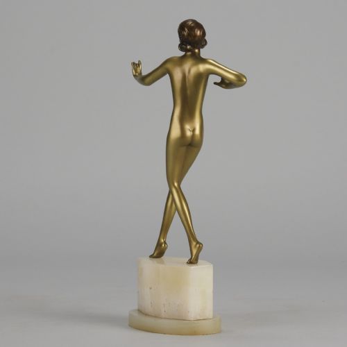 fig 5. An Art Deco cold-painted bronze figurine depicting a slender female dancer posed on a square onyx base.