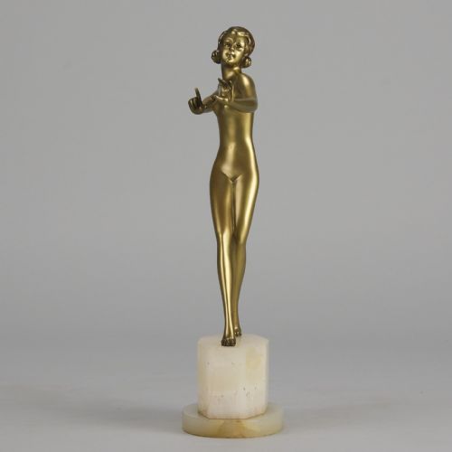fig 7. An Art Deco cold-painted bronze figurine depicting a slender female dancer posed on a square onyx base.