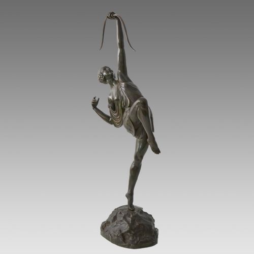 fig 1. A dark patinated bronze Art Deco sculpture depicting Diana the Huntress poised dynamically on a rocky base with a bow held overhead.