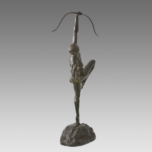 fig 2. A dark patinated bronze Art Deco sculpture depicting Diana the Huntress poised dynamically on a rocky base with a bow held overhead.