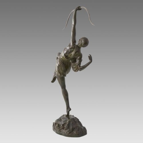 fig 3. A dark patinated bronze Art Deco sculpture depicting Diana the Huntress poised dynamically on a rocky base with a bow held overhead.