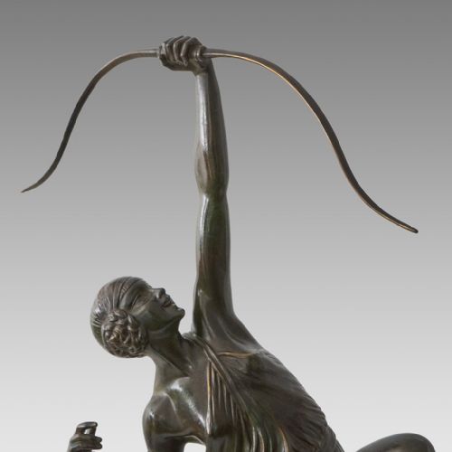 fig 6. A dark patinated bronze Art Deco sculpture depicting Diana the Huntress poised dynamically on a rocky base with a bow held overhead.
