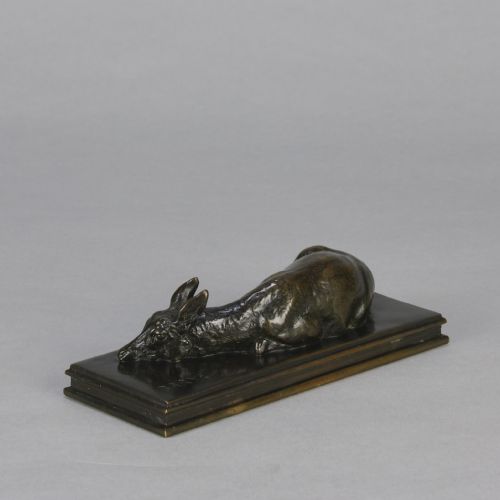 fig 4. A dark brown patinated bronze sculpture depicting a reclining doe resting on a rectangular bronze base signed Barye.