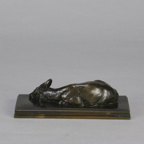 fig 5. A dark brown patinated bronze sculpture depicting a reclining doe resting on a rectangular bronze base signed Barye.